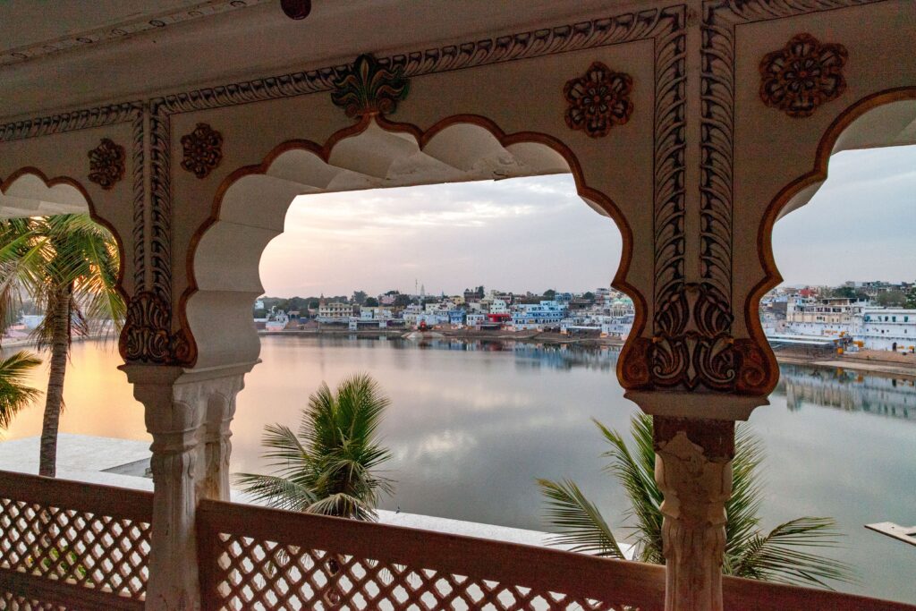 A stunning view of Pushkar Lake and cityscape from a temple balcony in Rajasthan, India.
