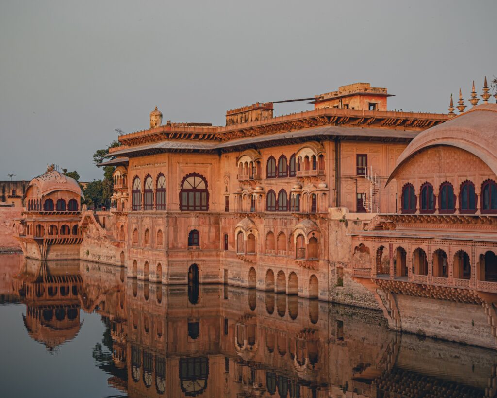 Stunning view of Deeg Palace architecture reflecting in the serene waters of Deeg, India.